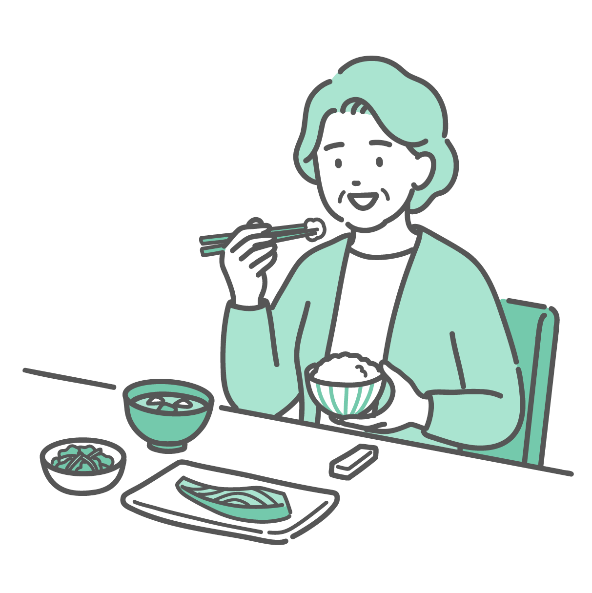 和食の定食を食べている笑顔の高齢女性